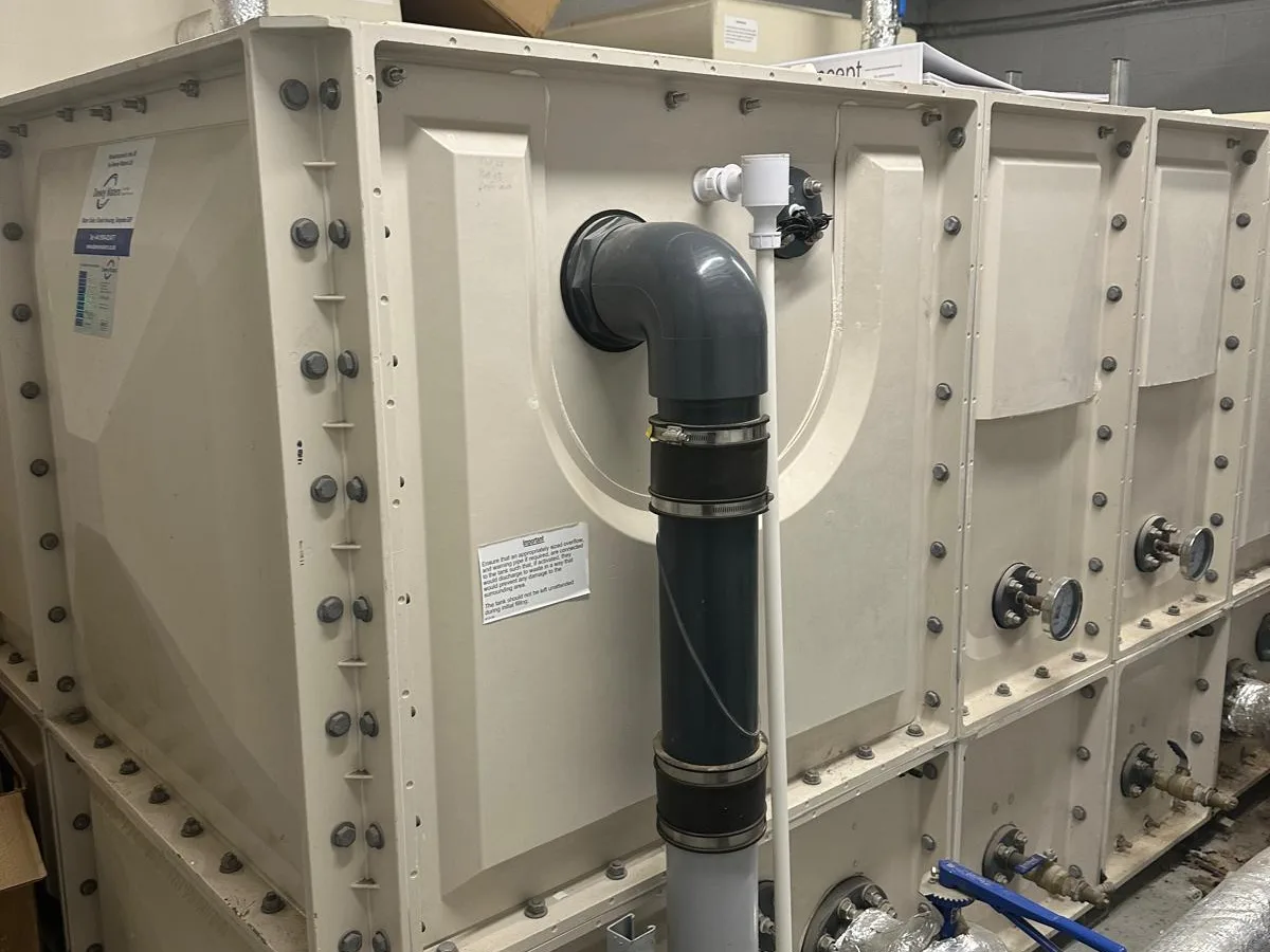 A sectional cold water storage tank in a plant room