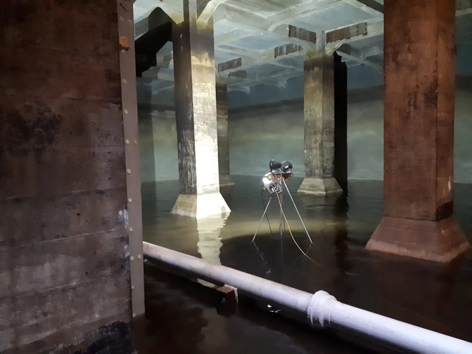 A remote inspection camera surveying inside a flooded service reservoir